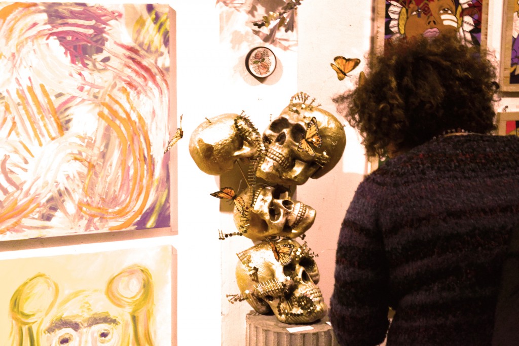 A person looking at some gold skulls on display