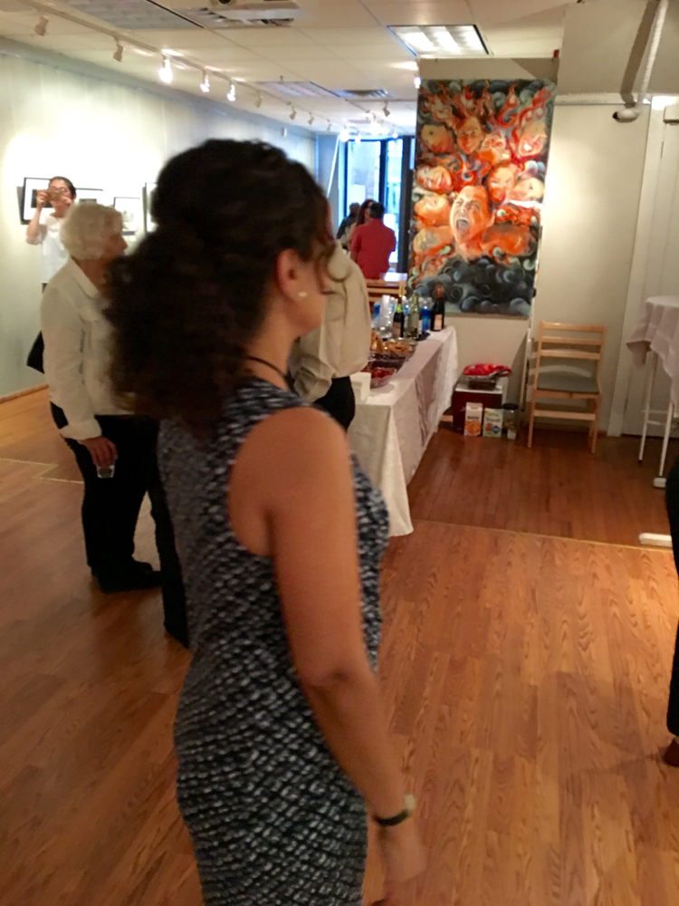 A woman standing in front of other people.
